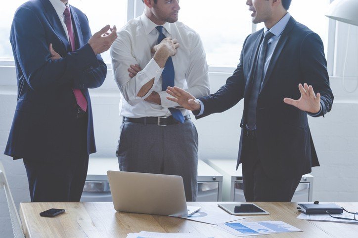 Business principals discussing different perspectives on a transaction