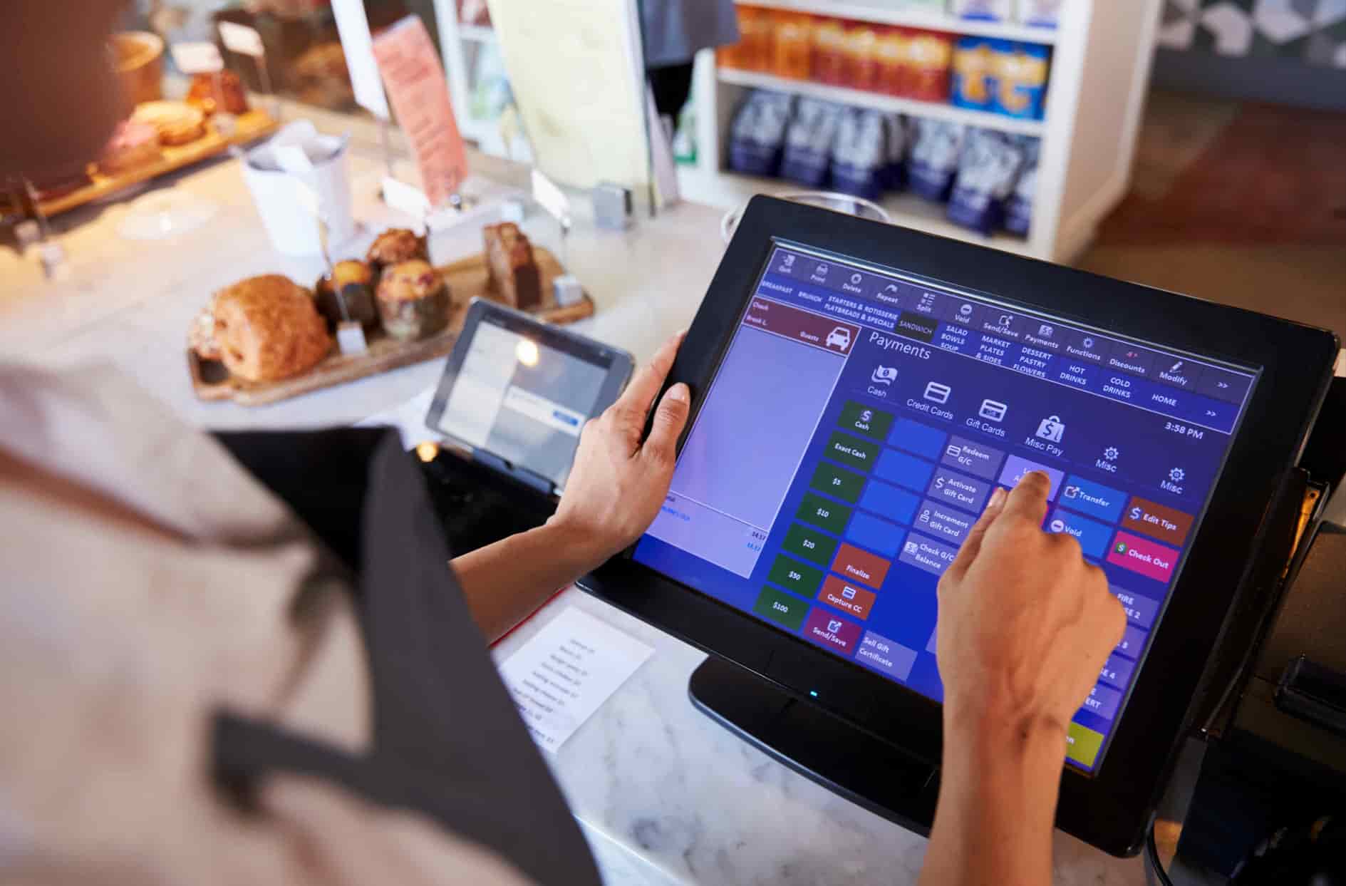 worker in a deli entering information into a system