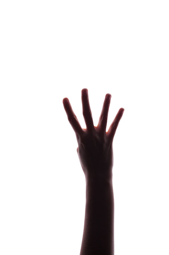 A hand holding up 4 fingers against a white background