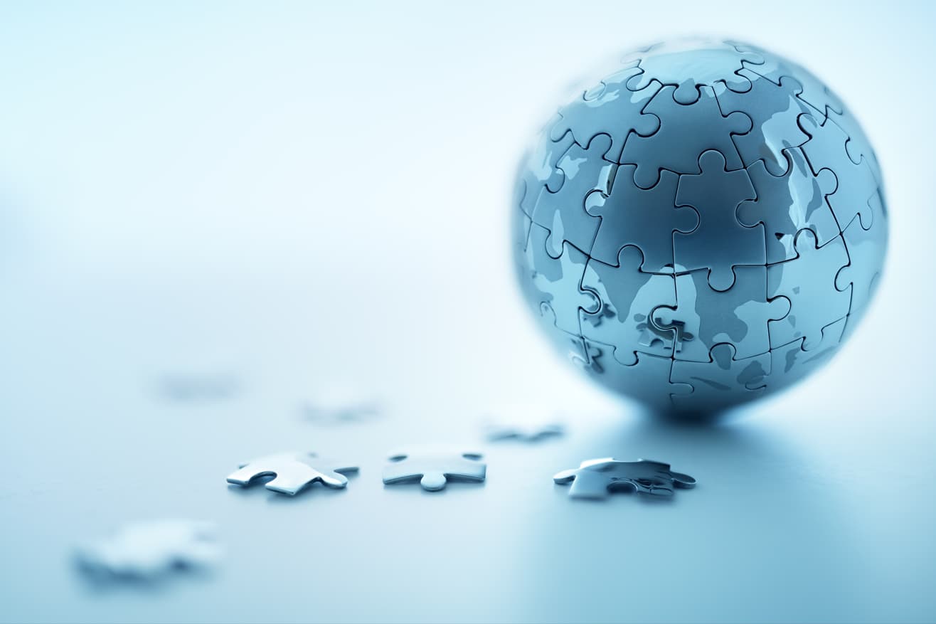 AB Integrated Services - an Integrated World - 3D Globe Puzzle with Pieces Next to It