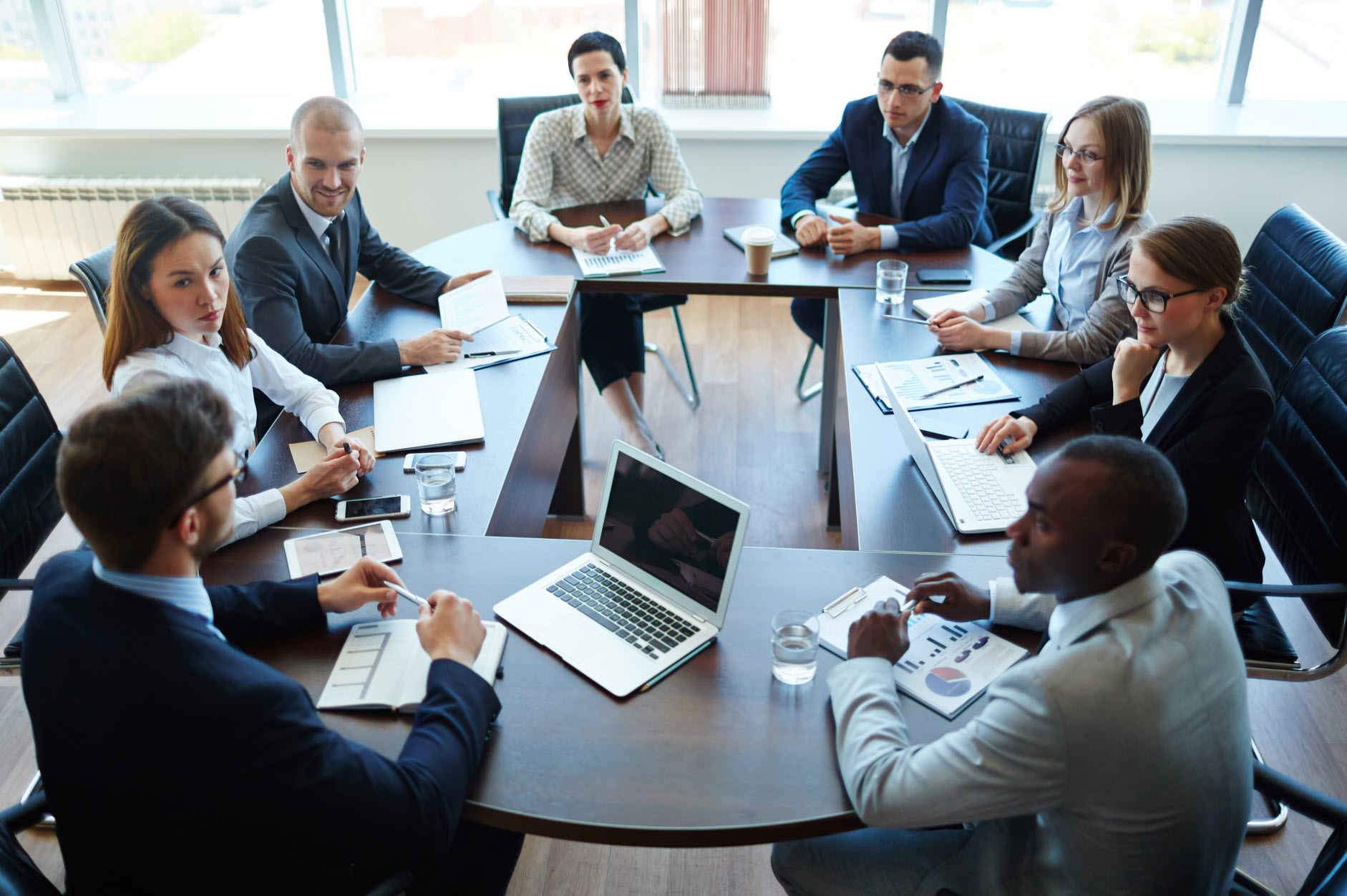 Business professionals coordinating accounting, tax, legal, and advisory services during a strategic meeting
