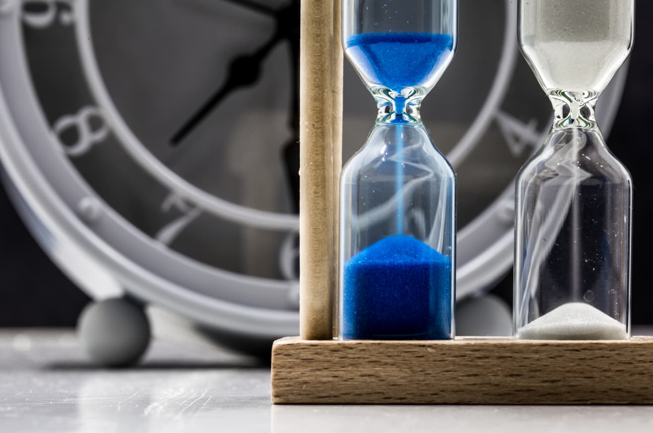 Hourglasses and clock representing timing and deadlines